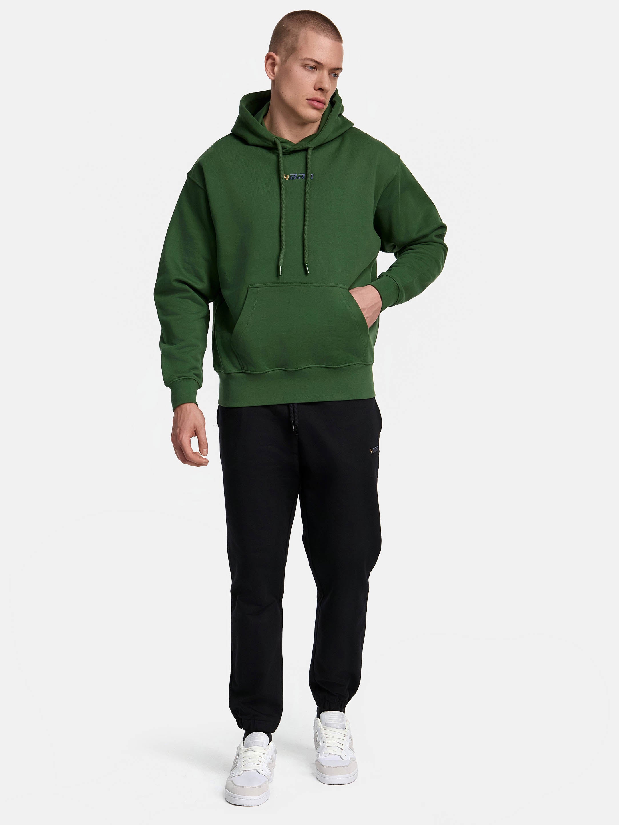 Premium hoodie in gruen ansicht von vorne in kombination mit schwarzer sweatpants
